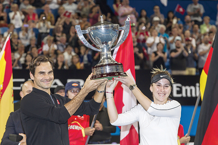PERTH: Roger Federer and his mixed doubles partner Belinda Bencic of Switzerland with the Hopman Cup after defeating runners-up Alexander Zverev and Angelique Kerber of Germany in the final on day eight of the Hopman Cup tennis tournament in Perth yesterday. —AFP