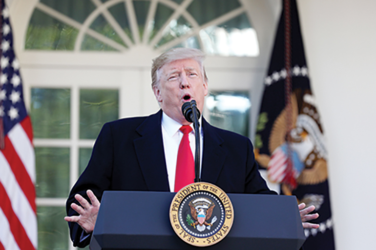 TOPSHOT - US President Donald Trump speaks about the government shutdown on January 25, 2019, from the Rose Garden of the White House in Washington, DC. - Trump says will sign bill to reopen the government until February 15. (Photo by Alex Edelman / AFP)