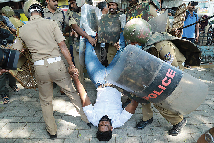 KOCHI: Police detain an Indian activist amid demonstrations after women entered the Sabarimala temple.— AFP
