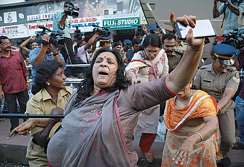 KOCHI: India police intervene as members of Sabarimala Karma Samithi try to disrupt a celebratory meeting after two women entered Sabarimala Ayyapa temple, at the High Court Junction. —AFP
