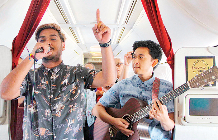 This handout from Garuda Indonesia shows musicians performing on a flight from Jakarta to Bali. — AFP photos