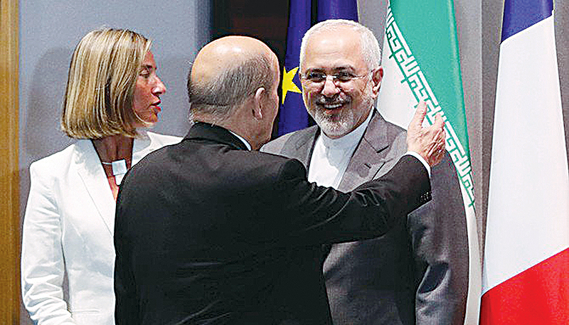 BRUSSELS: In this file photo, Iran’s Foreign Minister Mohammad Javad Zarif (right) stands next to France’s Foreign Minister Jean-Yves Le Drian (center) and EU High Representative for Foreign Affairs Federica Mogherini in Brussels. —AFP