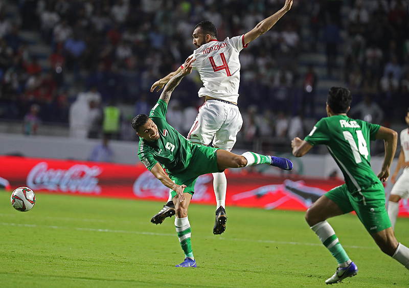 DUBAI: Iran's defender Roozbeh Cheshmi (top) fights for the ball against Iraq's midfielder Ahmed Yasin during the 2019 AFC Asian Cup group D football match between Iran and Iraq at the Maktoum Stadium in Dubai yesterday. - AFP
