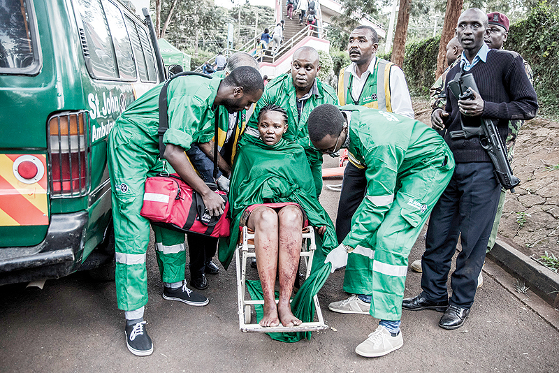 NAIROBI: An injured woman is evacuated from the scene of an explosion at a hotel complex in Nairobi’s Westlands suburb. — AFP