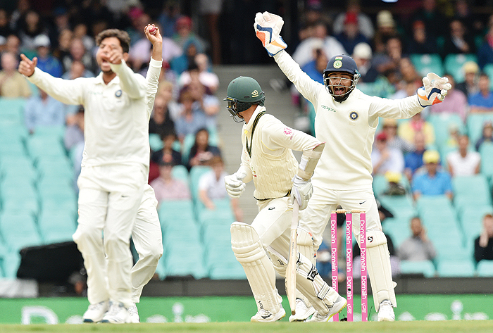 SYDNEY: Australia's batsman Nathan Lyon is bowled LBW by India's Kuldeep Yadav (L), as India's wicketkeeper Rishabh Pant (R) shouts, on the fourth day of the fourth and final cricket Test at the Sydney Cricket Ground in Sydney yesterday. - AFPn