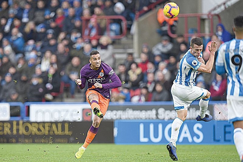 HUDDERSFIELD: Manchester City's Brazilian defender Danilo (L) shoots past Huddersfield Town's English midfielder Jonathan Hogg (R) but over the bar during the English Premier League football match between Huddersfield Town and Manchester City at the John Smith's stadium in Huddersfield, northern England yesterday. - AFP