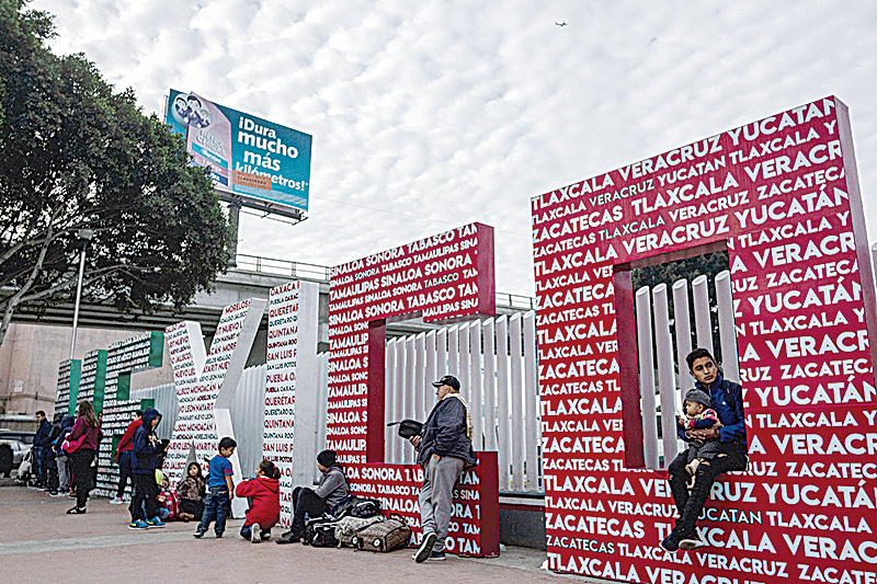 TIJUANA: Asylum seekers wait at El Chaparral crossing port at the US-Mexico border, in Tijuana, Baja California state, Mexico. —AFP