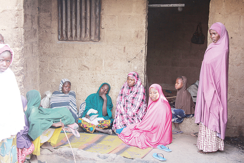 MAIDUGURI: Women sit outside their house at the Sajeri village on the outskirts of the Borno state capital. — AFP