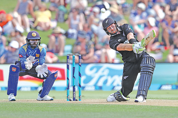 MOUNT MAUNGANUI: New Zealand’s Martin Guptill (R) plays a shot watched by Sri Lanka’s Niroshan Dickwella (L) during the first oneday international cricket match between New Zealand and Sri Lanka at Bay Oval. — AFP