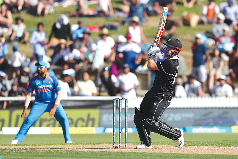 HAMILTON: New Zealand's Henry Nicholls (R) plays a shot during the fourth one-day international cricket match between New Zealand and India at Seddon Park in Hamilton yesterday. - AFP 