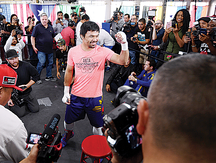 HOLLYWOOD: Manny Pacquiao laughs with the press during Manny Pacquiao versus Adrien Broner Media Day at Wild Card Boxing Club yesterday in Hollywood, California. - AFP