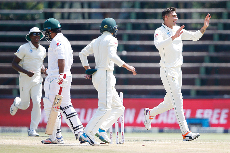 JOHANNESBURG: South African bowler Duanne Olivier (R) celebrates the dismissal of Pakistan batsman Sarfraz Ahmed (CL) during the fourth day of the third Cricket Test match between South Africa and Pakistan at Wanderers cricket stadium yesterday in Johannesburg.  - AFP