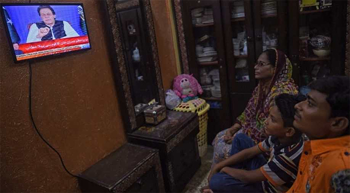 A Pakistani family watches television. ( AFP ) 