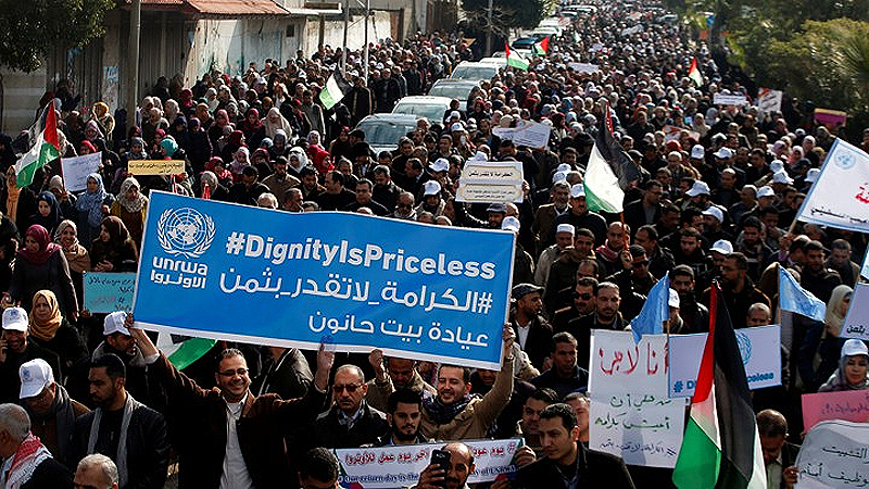 This is File Photo: Workers from the United Nations Relief and Works Agency for Palestine Refugees in the Near East protest January 29 in Gaza City against the U.S. decision to suspend aid. (Reuters)