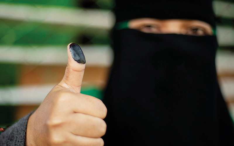 COTABATO, Philippines: A woman shows her inked thumb at a voting precinct on the southern Philippine island of Mindanao yesterday. - AFP 