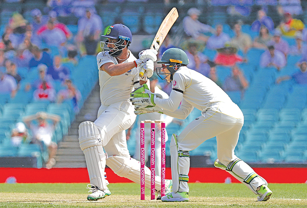 SYDNEY: India’s Cheteshwar Pujara hits a boundary in front of Australia’s captain and wicketkeeper Tim Paine during the first day of the fourth and final cricket Test at the Sydney Cricket Ground. — AFP