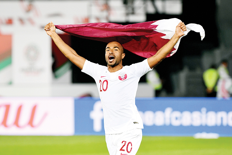 ABU DHABI: Qatar's midfielder Ali Yahya celebrates with the national flag after an Asian Cup quarterfinal match between South Korea and Qatar at Zayed Sports City on Jan 25, 2019. – AFP 