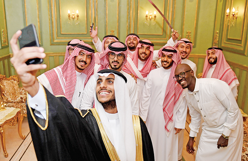 Saudi groom Basil Albani poses for a selfie with his friends during his wedding at his home in the Red Sea resort of Jeddah. — AFP photos