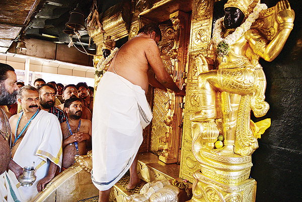 SABARIMALA, Kerala: An Indian priest closes the doors of the Ayyappa shrine at the Sabarimala temple after performing “purification” rituals following the entry of two women yesterday. — AFP