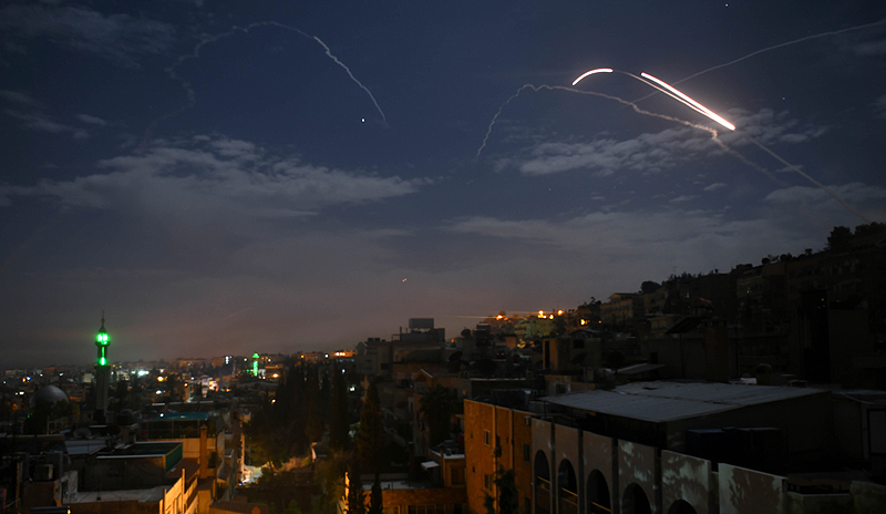 DAMASCUS: A picture taken early yesterday shows Syrian air defense batteries responding to Israeli missiles targeting the capital. - AFP 