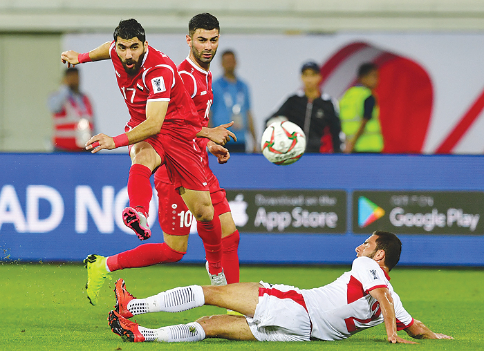 AL AIN: Syria's midfielder Youssef Kalfa (L) attempts a shot as he is marked by Jordan's defender Feras Shilbaya (R) during the 2019 AFC Asian Cup group B football match between Jordan and Syria at the Khalifa bin Zayed stadium in al-Ain yesterday. - AFPn