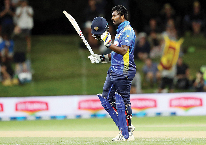 MOUNT MAUGANUI: Sri Lanka's Thisara Perera celebrates scoring a century (100 runs) during the second one-day international cricket match between New Zealand and Sri Lanka at Bay Oval in Mount Maunganui yesterday. --- AFPn