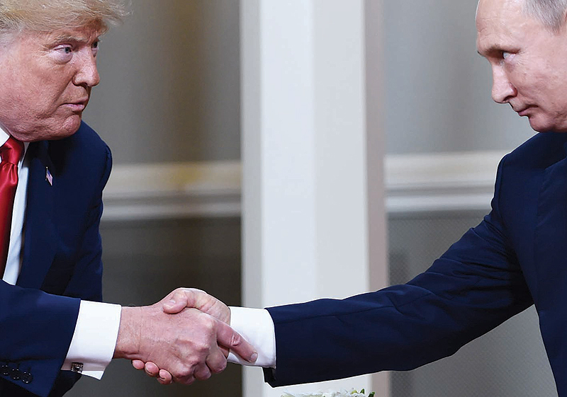 HELSINKI: In this file photo taken on July 16, 2018, US President Donald Trump and Russian President Vladimir Putin shake hands ahead of a meeting. —AFP
