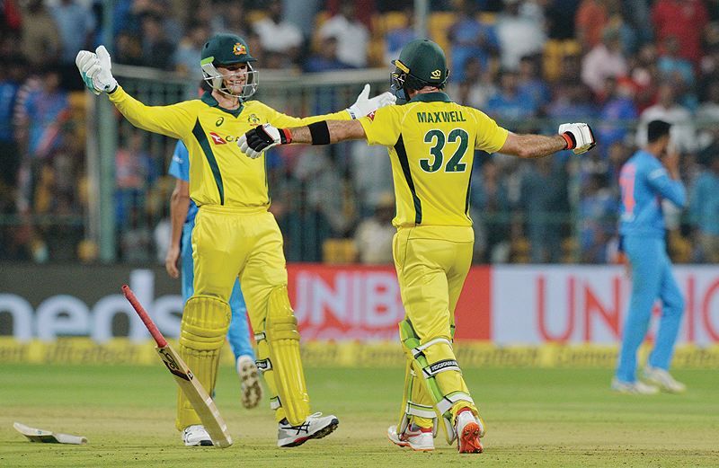 BANGALORE: Australian batsmen Glenn Maxwell (R) and Peter Handscomb embrace after victory in the second Twenty20 international cricket match between India and Australia at The M. Chinnaswamy Stadium in Bangalore yesterday, winning by seven wickets. - AFP 