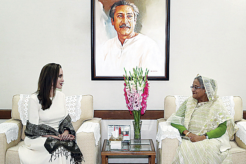 DHAKA: US actress, filmmaker and humanitarian Angelina Jolie (left), a special envoy for the United Nations High Commissioner for Refugees (UNHCR), looks on as she meets Bangladesh Prime Minister Sheikh Hasina following her visit in Dhaka. —AFP