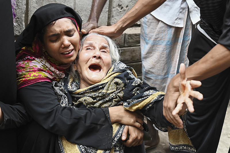 DHAKA: Relatives of victims mourn after a fire tore through apartment blocks in Bangladesh’s capital Dhaka yesterday. — AFP