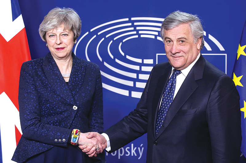 BRUSSELS: European Parliament President Antonio Tajani shakes hand with British Prime Minister Theresa May before a meeting at the European Parliament in Brussels.-AFP 