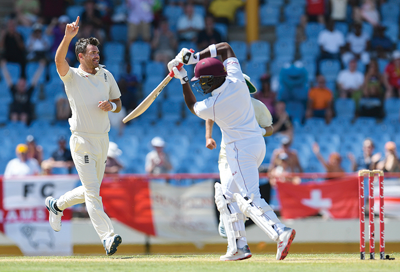 GROS ISLET: James Anderson (L) of England celebrates the dismissal of Darren Bravo (R) of West Indies during day 4 of the 3rd and final Test between West Indies and England at Darren Sammy Cricket Ground, Gros Islet, Saint Lucia, yesterday. — AFP