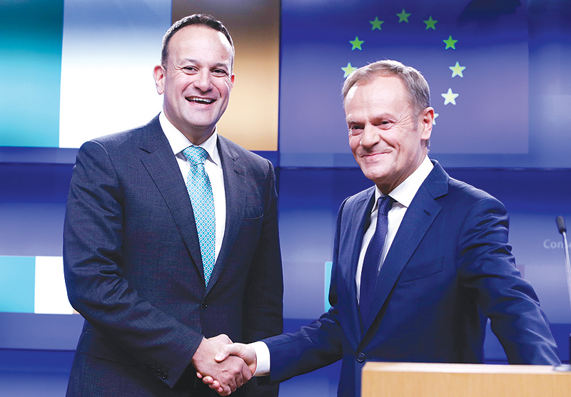 BRUSSELS: Ireland’s Prime Minister Leo Varadkar (L) and European Council President Donald Tusk shake hands after making a statement following a meeting yesterday at the European Council headquarters. — AFP