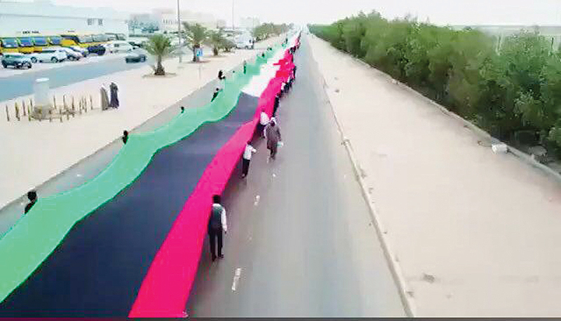 KUWAIT: Students rehearse ahead of a ceremony in which Kuwait will vie for a place in the Guinness Book of World Records through the world's longest national flag. - KUNA