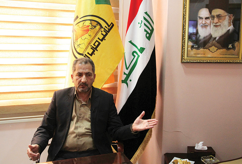  BAGHDAD: Iraq's spokesman for the Hezbollah Brigades Mohammed Mohie gestures during a news conference in Baghdad.-AFP  