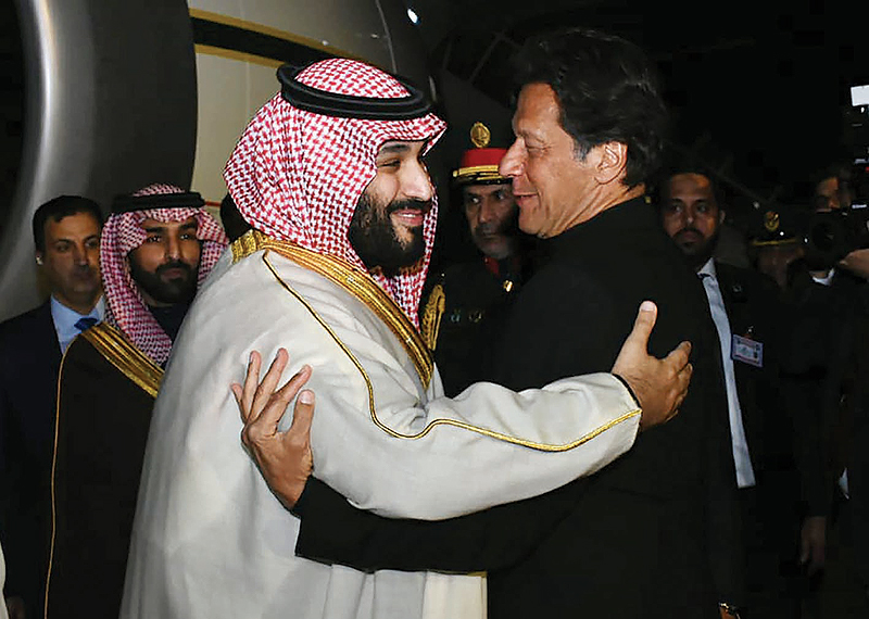 ISLAMABAD: Pakistani Prime Minister Imran Khan greets Saudi Crown Prince Mohammed bin Salman upon his arrival at the Nur Khan air force base yesterday. - AFP 