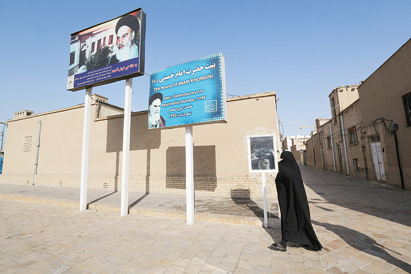 QOM, Iran: An Iranian woman walks past the house of the late founder of the Islamic Republic, Ayatollah Ruhollah Khomeini, in the holy city of Qom, 130 kilometers south of Tehran. - AFP 