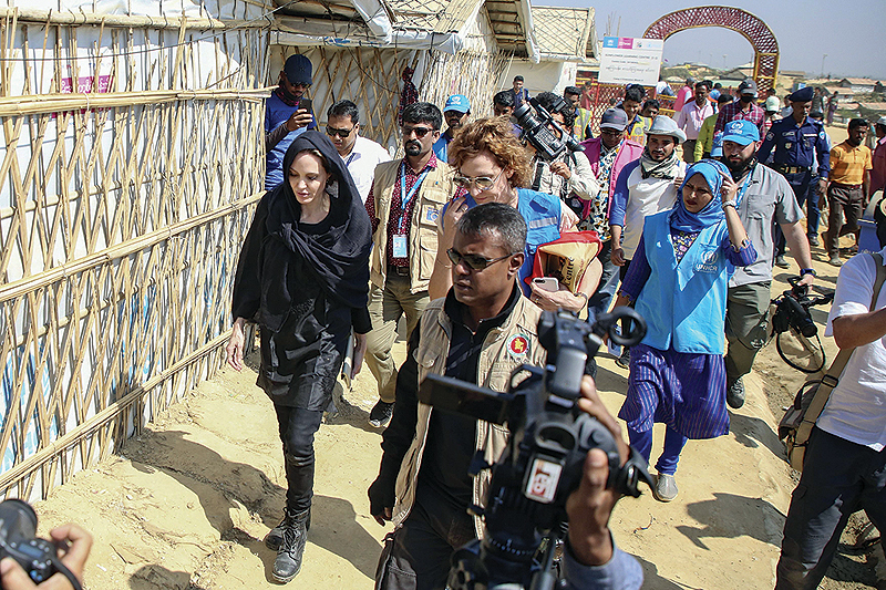 Angelina Jolie (left) visits a school in the Kutupalong camp for Rohingya refugees in Ukhia in southern Bangladesh yesterday.—AFP