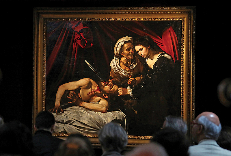 A painting, believed to be the second version of ‘Judith Beheading Holofernes’ by Italian artist Michelangelo Merisi da Caravaggio, is pictured during a photocall in London yesterday following its restoration. — AFP
