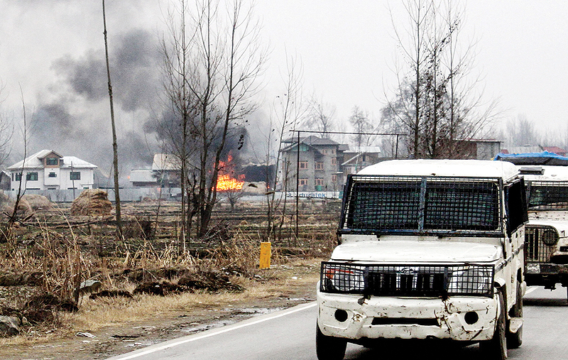 PULWAMA: A house in which militants are suspected to have sheltered is in flames after a gunfight between rebels and security forces yesterday. — AFP