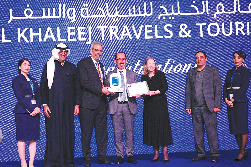 Kuwait Airways CEO Kamel Al-Awadhi awards representative of a travel agency during a ceremony held yesterday