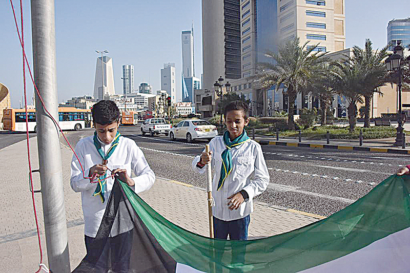 KUWAIT: Boy scouts prepare Kuwait’s flag to be raised at a square in Kuwait City as part of preparations for national celebrations. —KUNA
