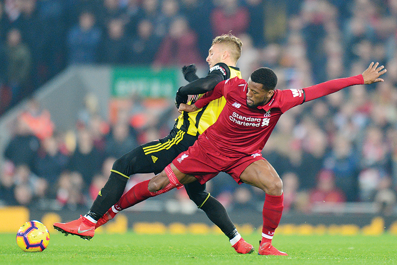 LIVERPOOL: Watford's Spanish midfielder Gerard Deulofeu (L) vies with Liverpool's Dutch midfielder Georginio Wijnaldum (R) during the English Premier League football match between Liverpool and Watford at Anfield in Liverpool, north west England on Wednesday. Liverpool won  the game 5-0. – AFP