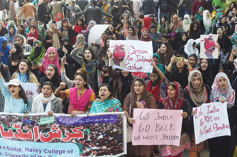 LAHORE: Pakistani students hold placards with the image of Abhinandan Varthaman, the Indian Air Force pilot captured by Pakistan authorities in Pakistan-administered Kashmir on February 27, and shout anti-India slogans during a protest in Lahore. — AFP