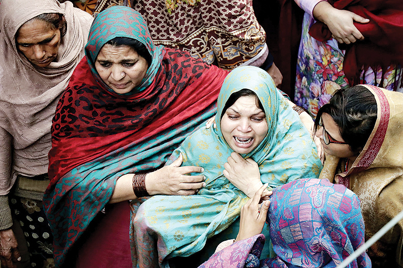 LAHORE: In this picture taken on Jan 20, 2019, relatives mourn the deaths of members of a family who were gunned down in a police encounter in Sahiwal, during their funeral. — AFP