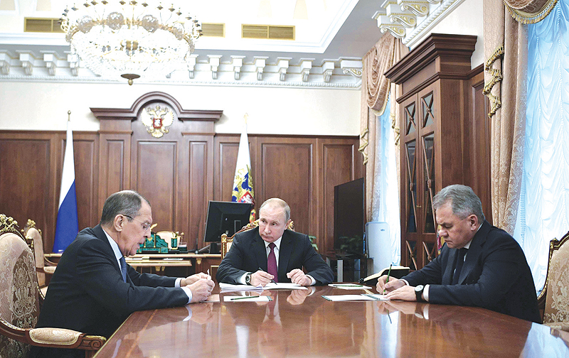 MOSCOW: Russia's President Vladimir Putin (C) attends a meeting with Russia's Foreign Minister Sergei Lavrov (L) and Defence Minister Sergei Shoigu. - AFP  