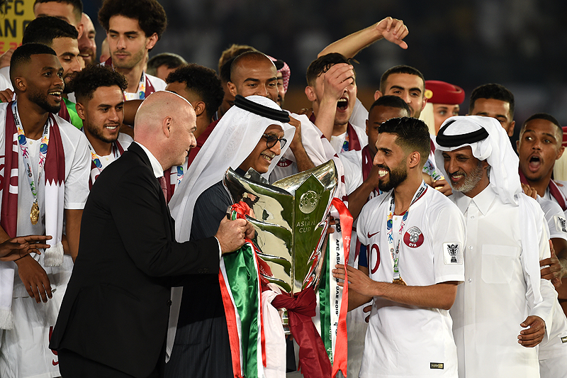 ABU DHABI: FIFA President Gianni Infantino (L) and AFC President Salman Al-Khalifa (2nd-L) present the cup to Qatar's forward Hasan Al Haydos (2nd-R) during the 2019 AFC Asian Cup final football match between Japan and Qatar at the Zayed Sports City Stadium in Abu Dhabi on Friday. – AFP
