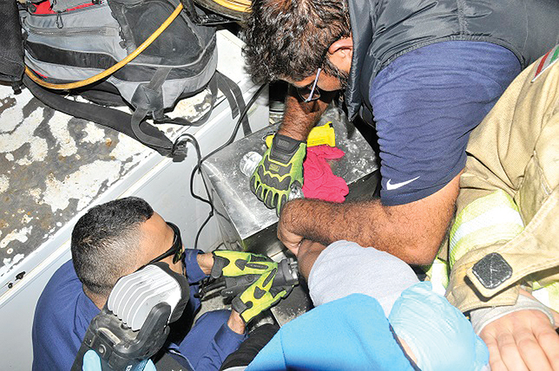 KUWAIT: Firefighters free a worker’s hand after it became trapped in a machine inside a restaurant in Mishref.