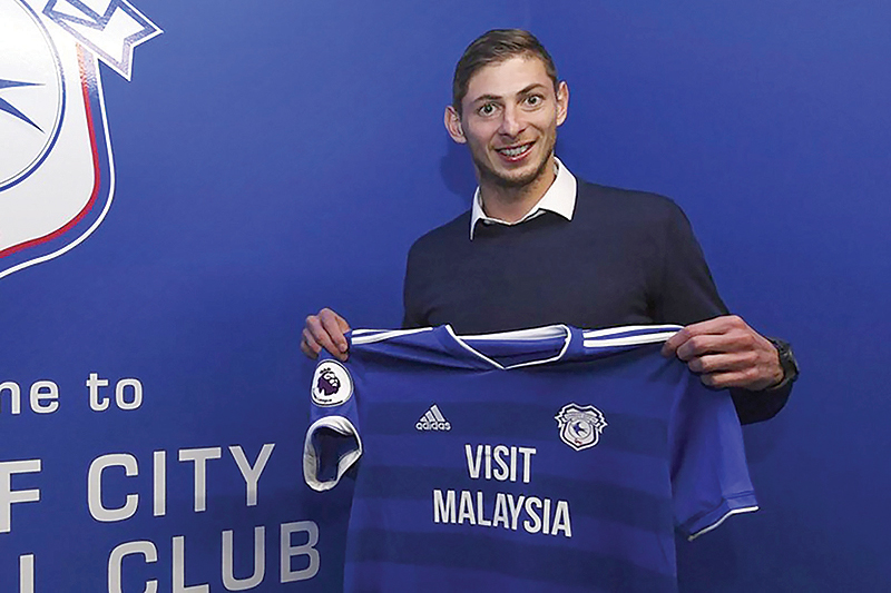 CARDIFF: File photo released by Cardiff City FC via Noticias Argentinas taken on January 20, 2019 showing Argentine footballer Emiliano Sala posing with Cardiff’s jersey after signing for the club, in Cardiff, UK. — AFP