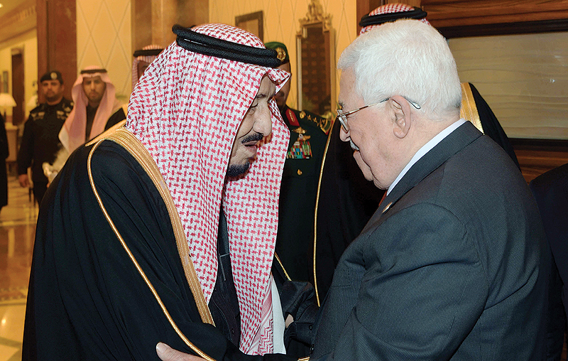 RIYADH: Saudi King Salman bin Abdulaziz greets Palestinian President Mahmoud Abbas before a meeting yesterday. — AFP